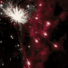 a bunch of fireworks are flying in the night sky