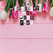 a pink wooden background with flowers and the words on wednesdays we wear pink