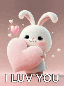 a stuffed bunny holding a pink heart with the words i luv you below it