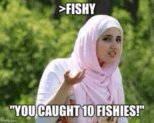 a woman in a pink hijab is making a funny face and says `` fishy you caught 10 fishies ! ''