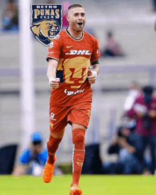 a soccer player wearing a retro pumas uniform runs on the field