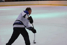 a hockey player wearing a jersey that says tribute on the back