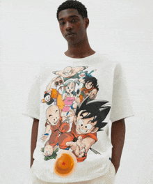 a man is wearing a white t-shirt with a dragon ball cartoon on it