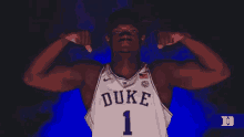 a duke basketball player flexes his muscles in the dark