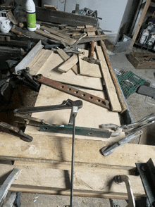 a bottle of glue sits on top of a pile of wooden pieces