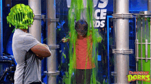 a man with a green head is standing next to a boy covered in green slime and a sign that says ice awards