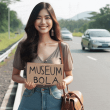 a woman holds up a sign that says museum bola