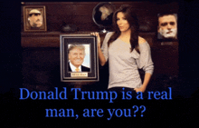 a woman holding a framed picture of donald trump with the caption donald trump is a real man are you