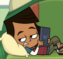 a cartoon boy is laying on a couch looking at a tablet