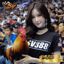 a woman holding a rooster wearing a black shirt with sv388 on it