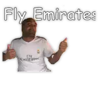 a man is wearing a fly emirates shirt and giving a thumbs up