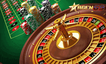 a roulette wheel with chips and a sign that says agen 69