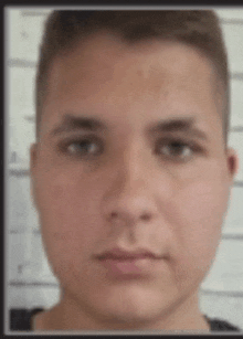 a close up of a young man 's face with a blurred background