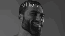 a man with a beard is smiling in a black and white photo that says of kors