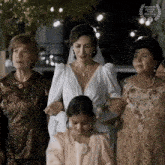 a woman in a wedding dress is surrounded by older women and a laurel wreath that says atlanta black film festival