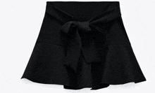 a black skirt with ruffles and a bow