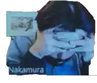 a person covering their face with their hands and the name nakamura is on the bottom