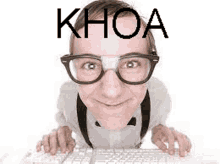 a man with glasses and suspenders is typing on a keyboard .