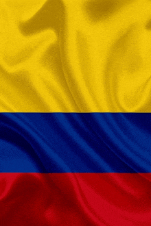 the flag of colombia is yellow blue and red and is waving in the wind