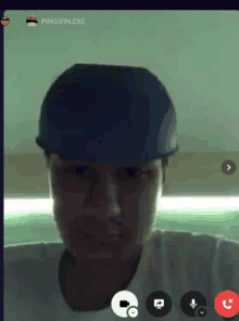 a man wearing a blue hat is on a video call with pingvin.exe in the corner