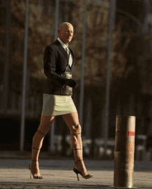 a man wearing a green skirt and high heels is walking down the street