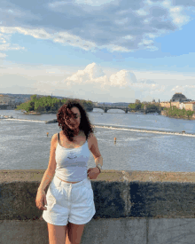 a woman wearing a white tank top that says ' i love you ' on it