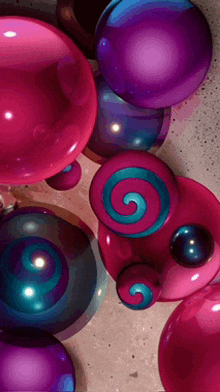 a bunch of pink and purple balls with a blue swirl