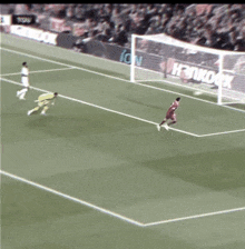 a soccer game is being played in front of a banner that says " hankook "