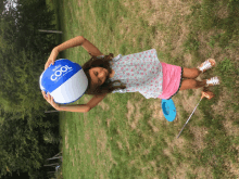 a girl is holding a beach ball with the word cool on it