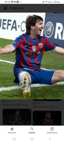 a soccer player wearing a unicef jersey is kneeling down on the field