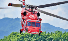 a red helicopter with the numbers na-702 on the side of it