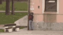 a person standing on the side of a building with graffiti on the wall that says a.s.