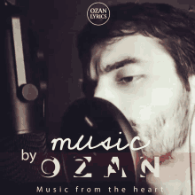 a black and white photo of a man singing into a microphone with the words music by ozan music from the heart