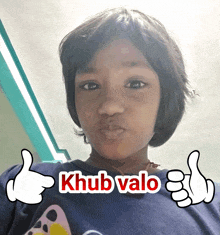 a young girl giving a thumbs up with the words khub valo written above her