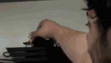 a close up of a person 's hand holding a pencil .