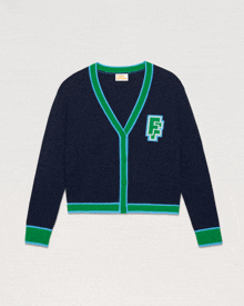 a blue and green cardigan with the letter f on the chest