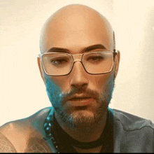 a bald man with glasses and a beard