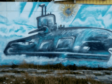 a painting of a submarine on a wall with a sun in the background