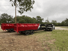 a red dumpster is being towed by a truck with a bed that says ' lonestar ' on it