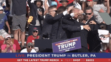 a man holding a sign that says trump in front of a crowd