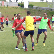 a group of soccer players are playing on a field and one of them is wearing a jersey that says ' new balance '