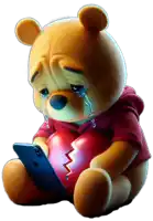 a teddy bear is crying while holding a broken heart