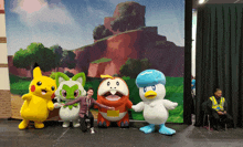 a group of mascots are posing for a picture