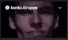 a close up of a man 's face with konkz.gruppe written on the top