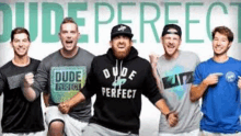 a group of young men are standing next to each other in front of a sign that says dude perfect .