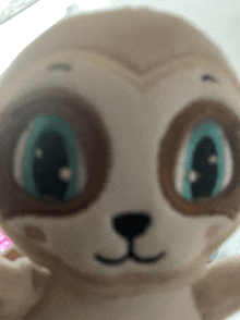 a close up of a stuffed animal with a blue eye