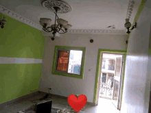 a living room with green and white walls and a red heart in the middle