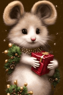 a mouse is holding a red christmas present in its hands .