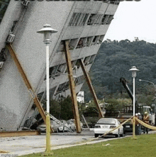 a large building is being demolished in a city .