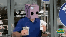 a man wearing a cardboard box on his head holding money